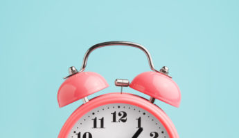 Red alarm clock on ablue background