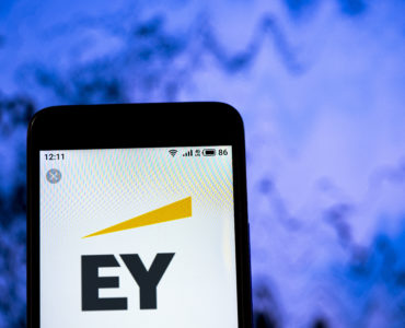 KYIV /KIEV, UKRAINE - July, 4, 2019: In this photo illustration the Ernst & Young logo is seen displayed on a smartphone