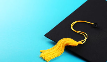 Graduation cap on blue background