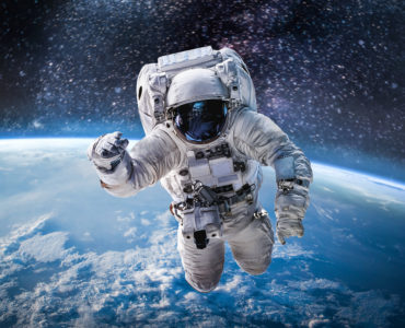 Astronaut in the outer space over the planet Earth. Abstract wallpaper. Spaceman. Elements of this image furnished by NASA