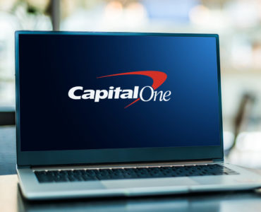 POZNAN, POL - JAN 6, 2021: Laptop computer displaying logo of Capital One Financial Corporation, a bank holding company specializing in credit cards, auto loans, banking, and savings accounts.