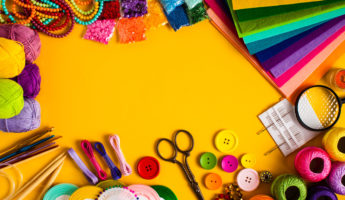 Craft and hobby materials on the yellow background, flat lay
