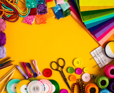 Craft and hobby materials on the yellow background, flat lay