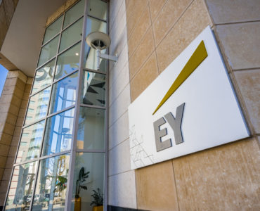 November 25, 2018 San Jose / CA / USA - EY logo next to the entrance to their offices in downtown San Jose, south San Francisco bay area