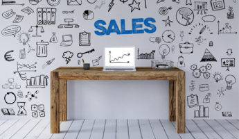 Sale concept with sales slogan in the workplace with desk and laptop