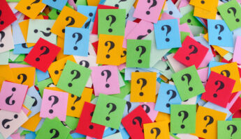 Too Many Questions. Big pile of colorful paper notes with question marks. Closeup.