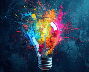 Creative explosion of a light bulb with vibrant paint splashes Innovation and creativity concept