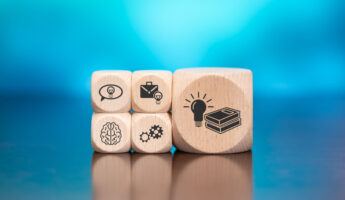 Wooden blocks with symbol of knowledge concept on blue background