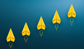 Yellow paper plane on blue background, Success in business growth concept