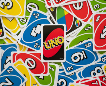 6 April 2019, Wuhan China : Uno game cards scattered all over the frame and one card showing the reverse side with Uno logo in the middle